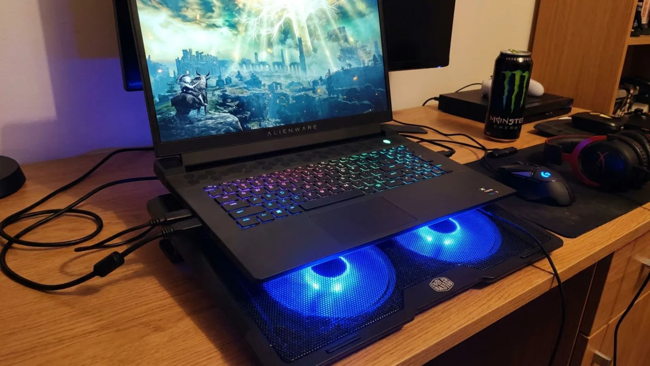 Laptop cooling pad with large fans underneath a gaming laptop.