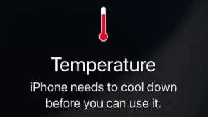 iPhone showing temperature warning screen with red thermometer icon.