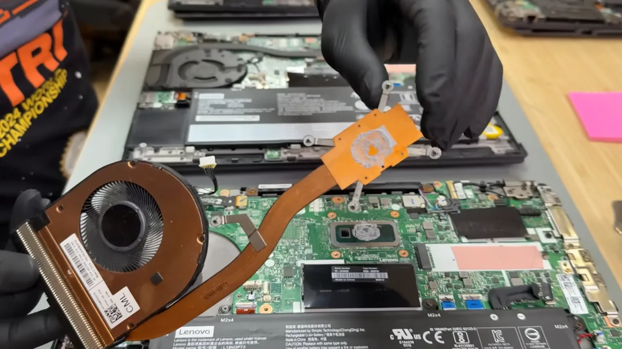 Dried gray thermal paste on the CPU die and the heat sink copper plates.