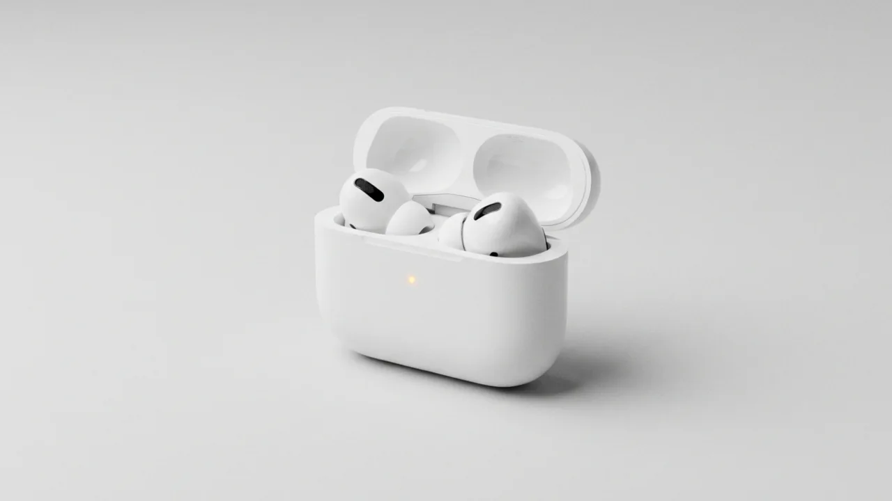 AirPods charging case lid open with amber status light on the front.