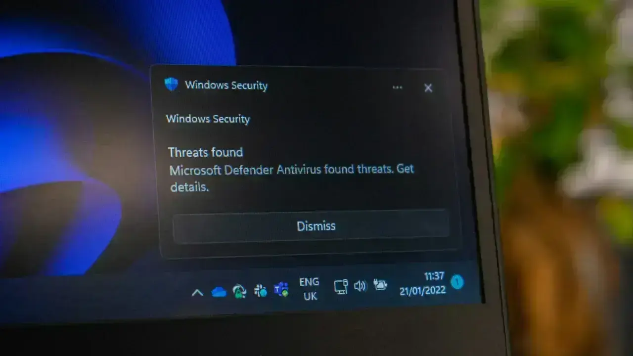 Windows Defender security threat alerts on laptop.